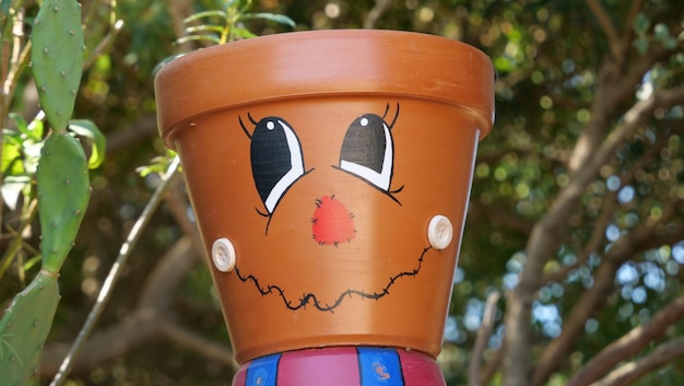 Brown pot with a cute face drawn on it