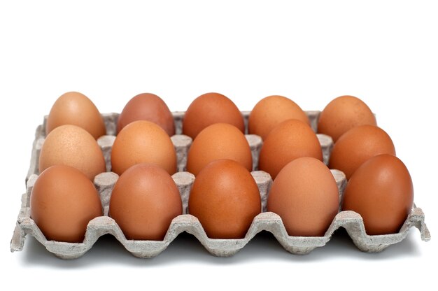 Brown raw chicken eggs in a cardboard box for eggs.Food background.