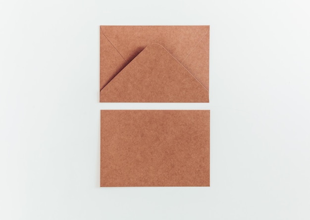 Brown recycle cardboard envelopes on the white background. Craft paper empty envelope template