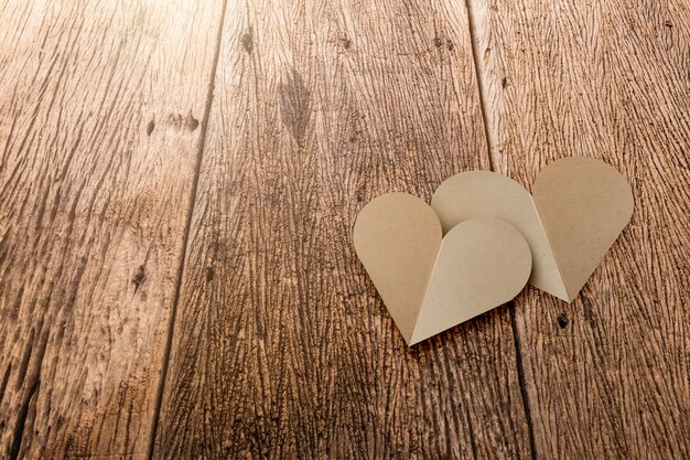 Brown recycle heart shape paper on old wwoden table