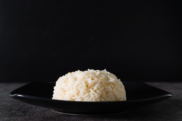 Brown rice or Coarse rice with black background. and copy space.