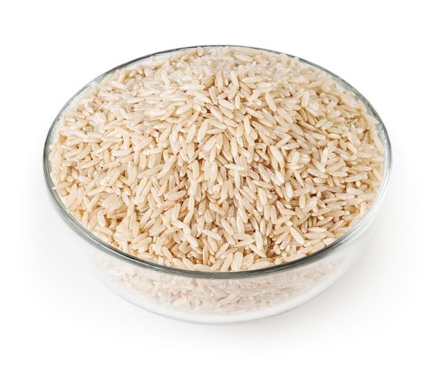 Brown rice in glass bowl isolated on white background with clipping path