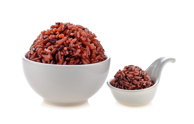 Brown rice in white bowl on white background