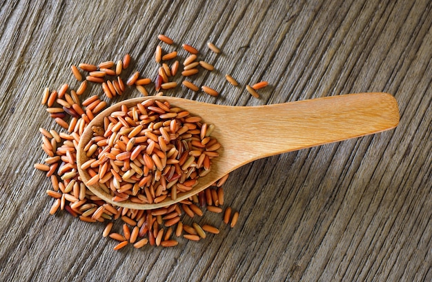 Brown rice  in wood spoon on table