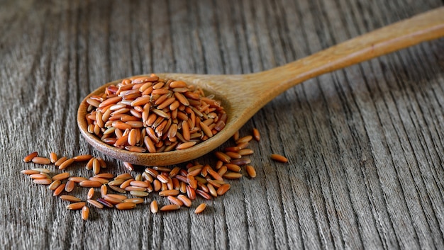 Brown rice  in wood spoon on table