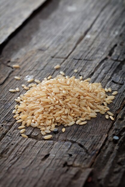 Brown rice on wooden surface