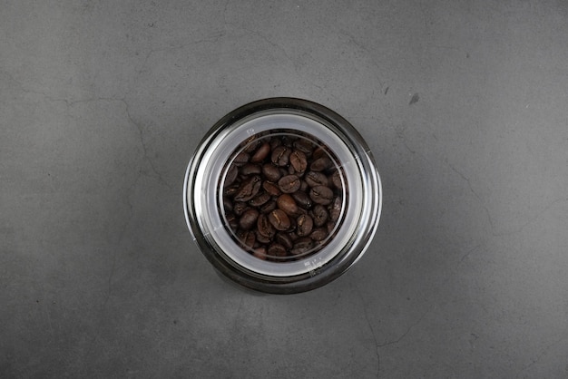 brown roasted coffee beans and coffee cup