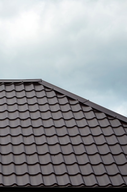 Brown roof tiles or shingles on house as background image