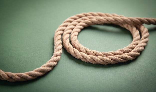 Brown rope on green background.