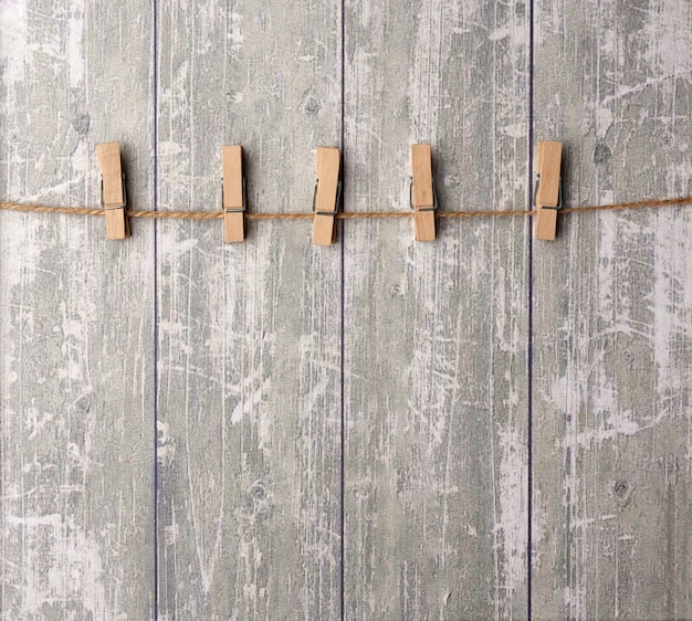 Brown rope and wooden clothespins, background for the designer