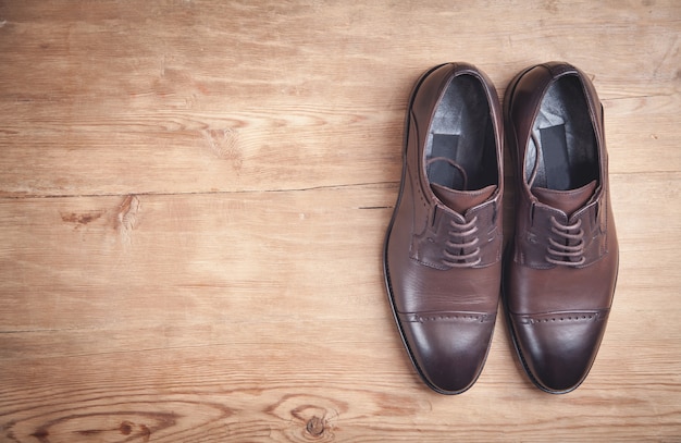 Brown shoes on the wooden background