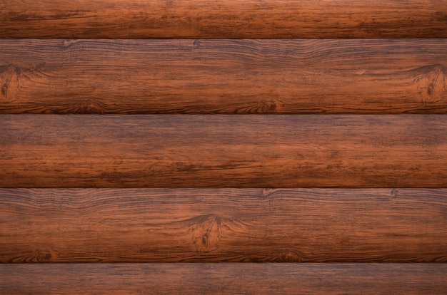 Brown siding on the wall of the house imitated wooden logs