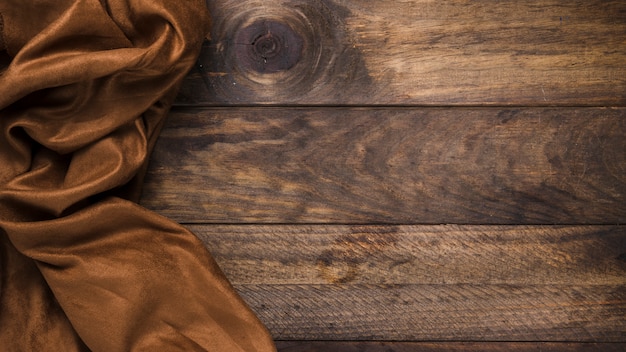 Brown silk textile on weathered wooden table