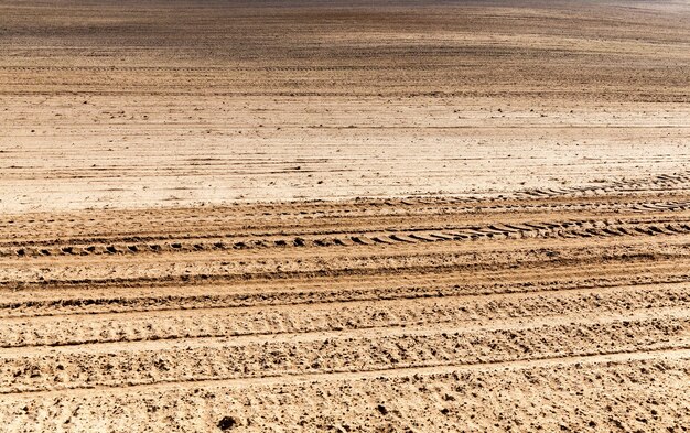 Brown soil of a plowed field during the preparation of soil for sowing a new crop of plants