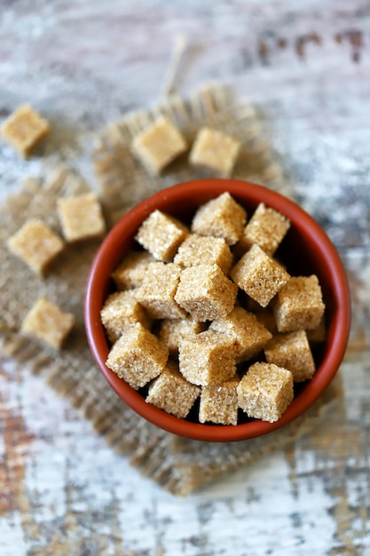 Brown sugar cubes in a bowl.