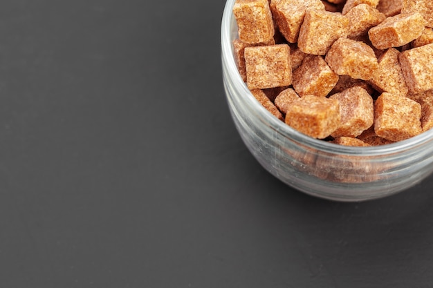 Brown sugar cubes on gray background