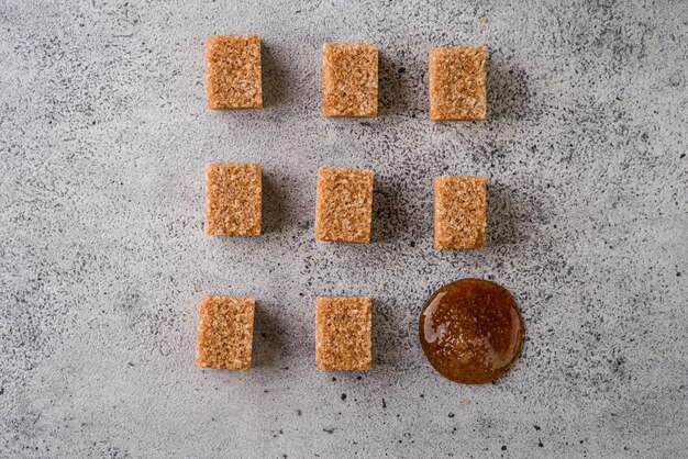 brown sugar cubes on a gray background