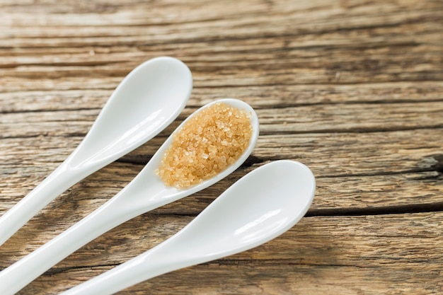 Brown sugar in spoon on the table