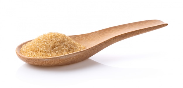 Brown sugar in wood spoon on white background