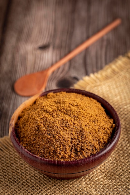 Brown sugar in wooden bowl on the table