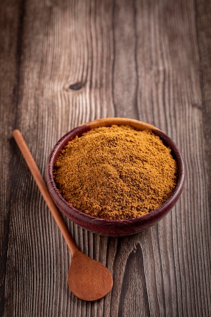 Brown sugar in wooden bowl on the table