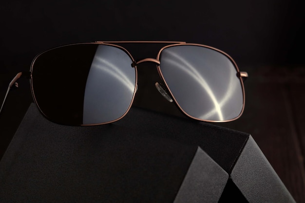 Brown Sunglass on the black case with dark background