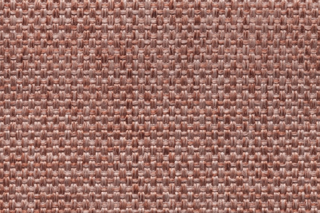 Brown textile background with checkered design, closeup.
