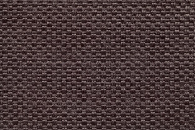 Brown textile background with checkered pattern, closeup. Structure of the fabric macro.