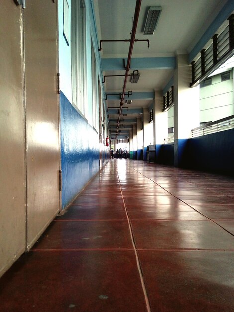 Brown tiled floor at corridor of building