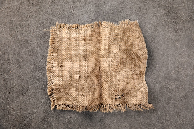 Photo brown torn piece of burlap jute fabric