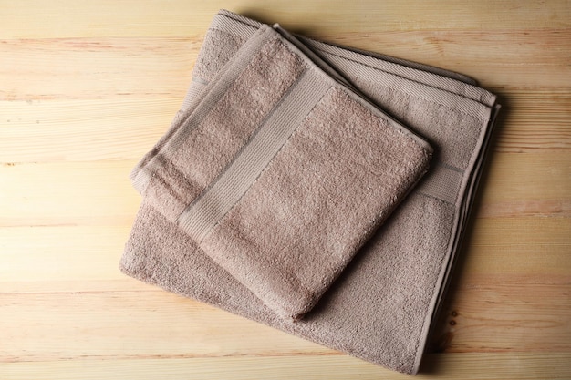 Brown towels on wooden background