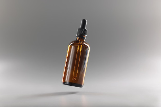 Brown transparent bottle with a pipette on a gray background, close-up. Dropper for medicines. Drop dispenser