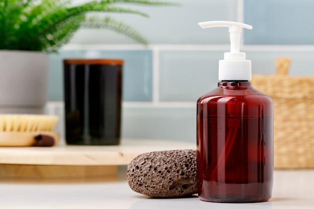 Brown transparent skincare product bottle with dispenser on a light background