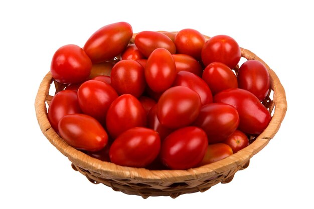 Brown wattled basket with red tomatoes isolated on white background