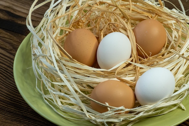 Brown and white eggs in a straw nest