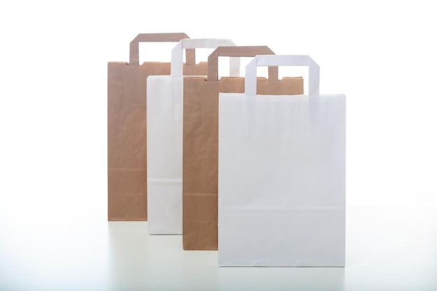 Brown and white paper shopping bags on white background