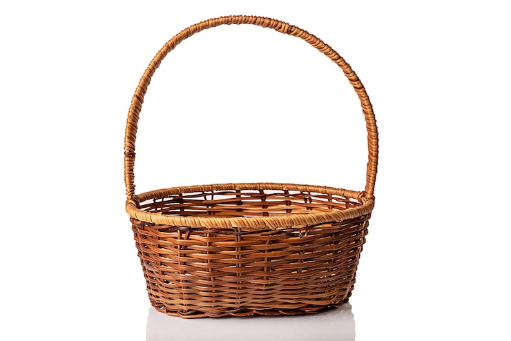 Photo brown wicker basket with handle. handmade. on white background.