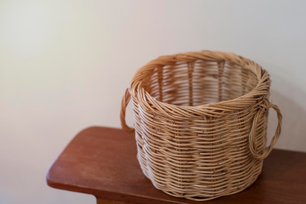 背後にセメントの壁がある木製のテーブルの上にある茶色の<unk>のバスケット