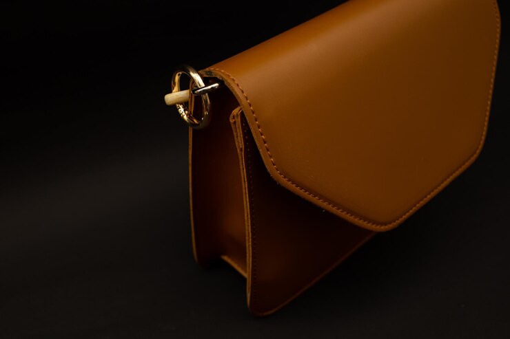 Brown women's clutch bag on a black background