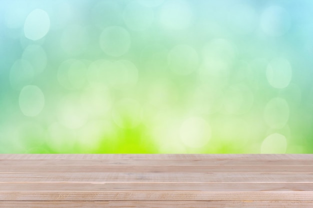 Brown wood table top on bokeh abstract green background can be used for montage