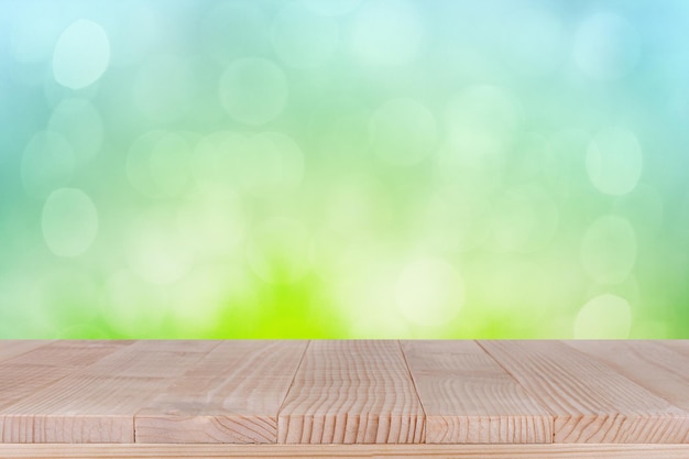 Brown wood table top on bokeh abstract green background can be used for montage