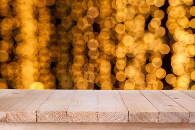 Photo brown wood table top on bokeh abstract orange background can be used for montage