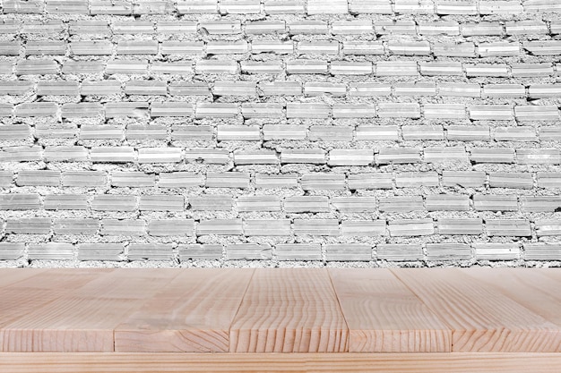 Brown wood table top on white concrete wall background can be used for montage