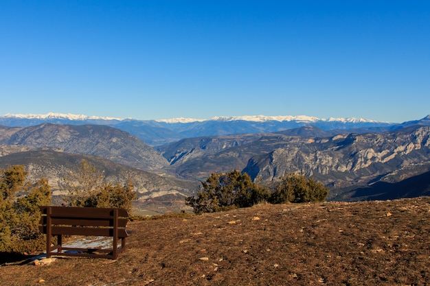 Brown wooden bench in the mountain