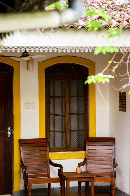 Photo brown wooden chairs beside the window photo