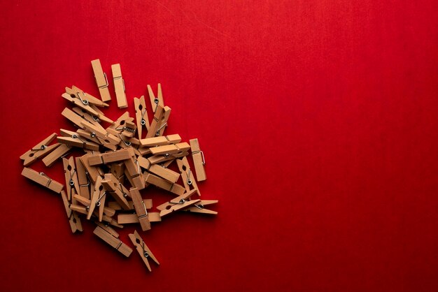 brown wooden clothespins woden clips on red background
