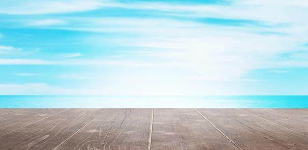 Brown wooden desk with sea and sky in background Clean surface for product presentation