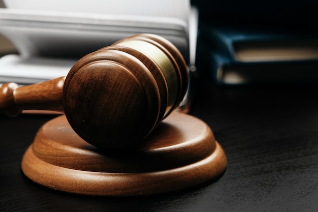 brown wooden judge mallet on the background of open book