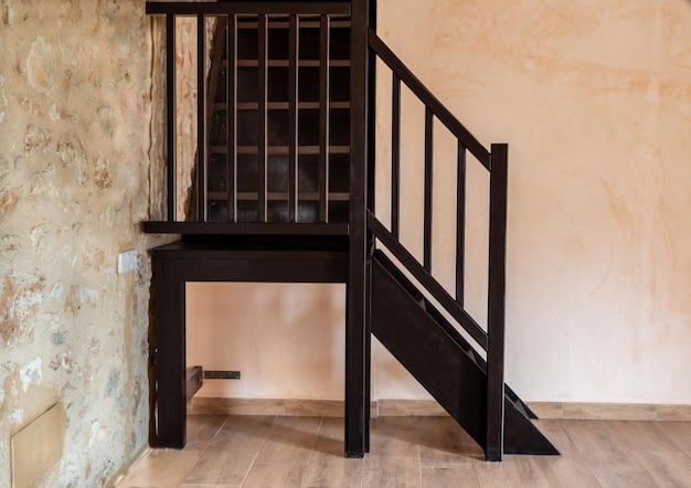 Brown wooden staircase in an empty bedroom