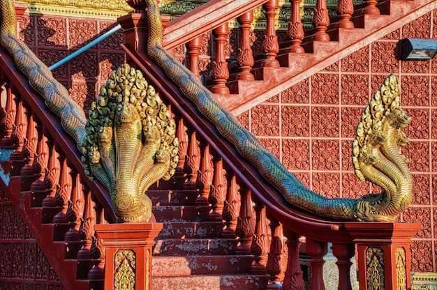 Photo brown wooden staircase with brown wooden railings photo